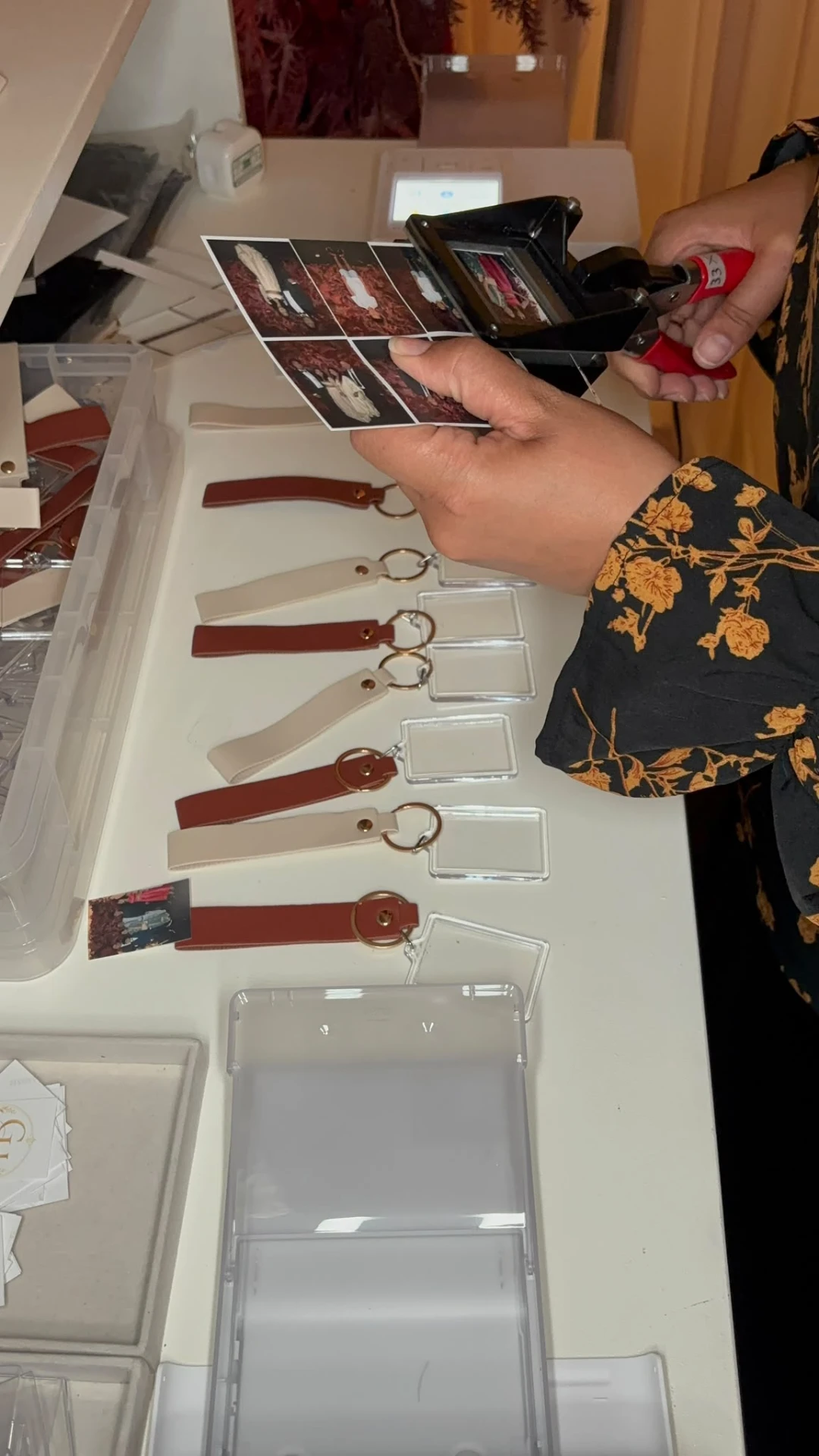 A photograph being trimmed and assembled into a leather keyring